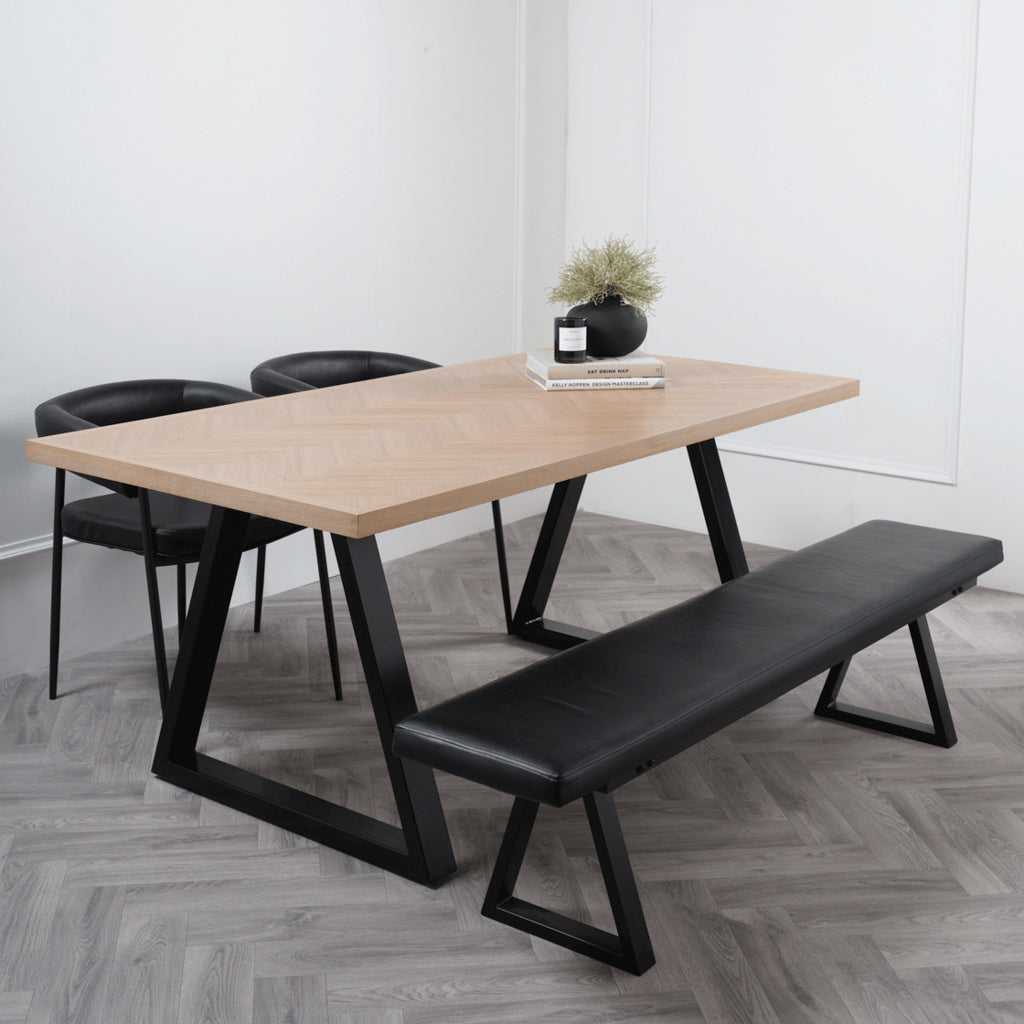 LPD Furniture Hyde natural wood herringbone dining table with black metal legs in a modern dining setting