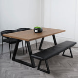 LPD Furniture Hyde whiskey wood herringbone dining table with black metal legs in a modern dining setting