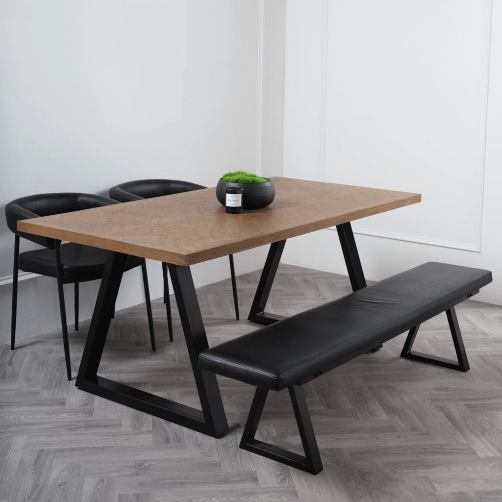 LPD Furniture Hyde whiskey wood herringbone dining table with black metal legs in a modern dining setting