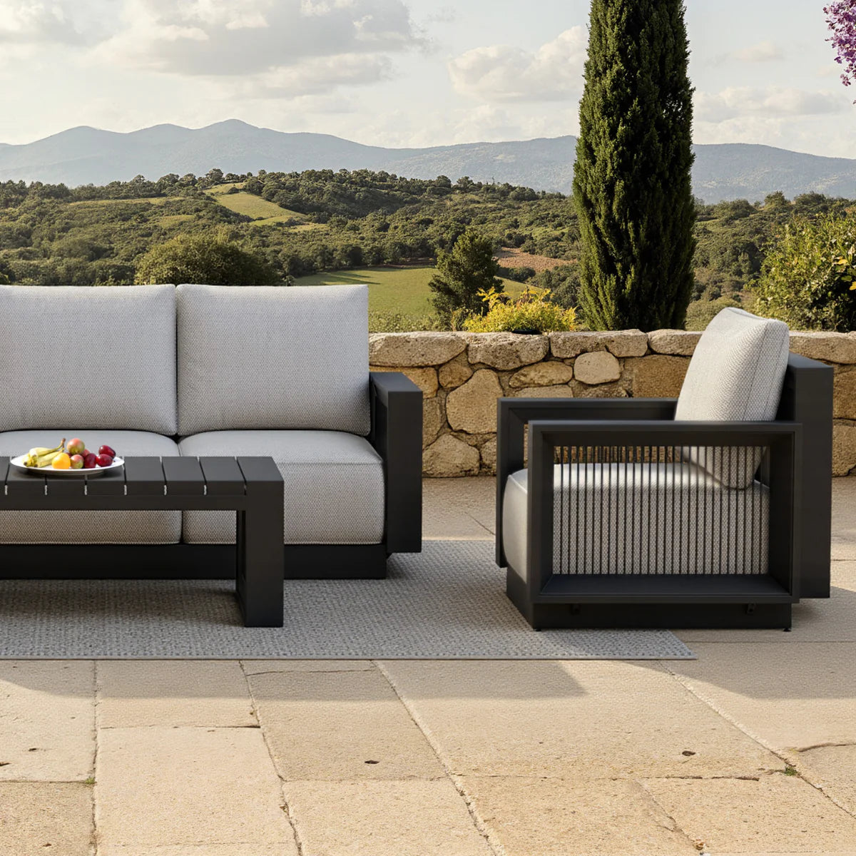 Furnish365 Ikos 5 seater outdoor lounge set with polyrattan wicker and aluminium frame in a modern garden setting