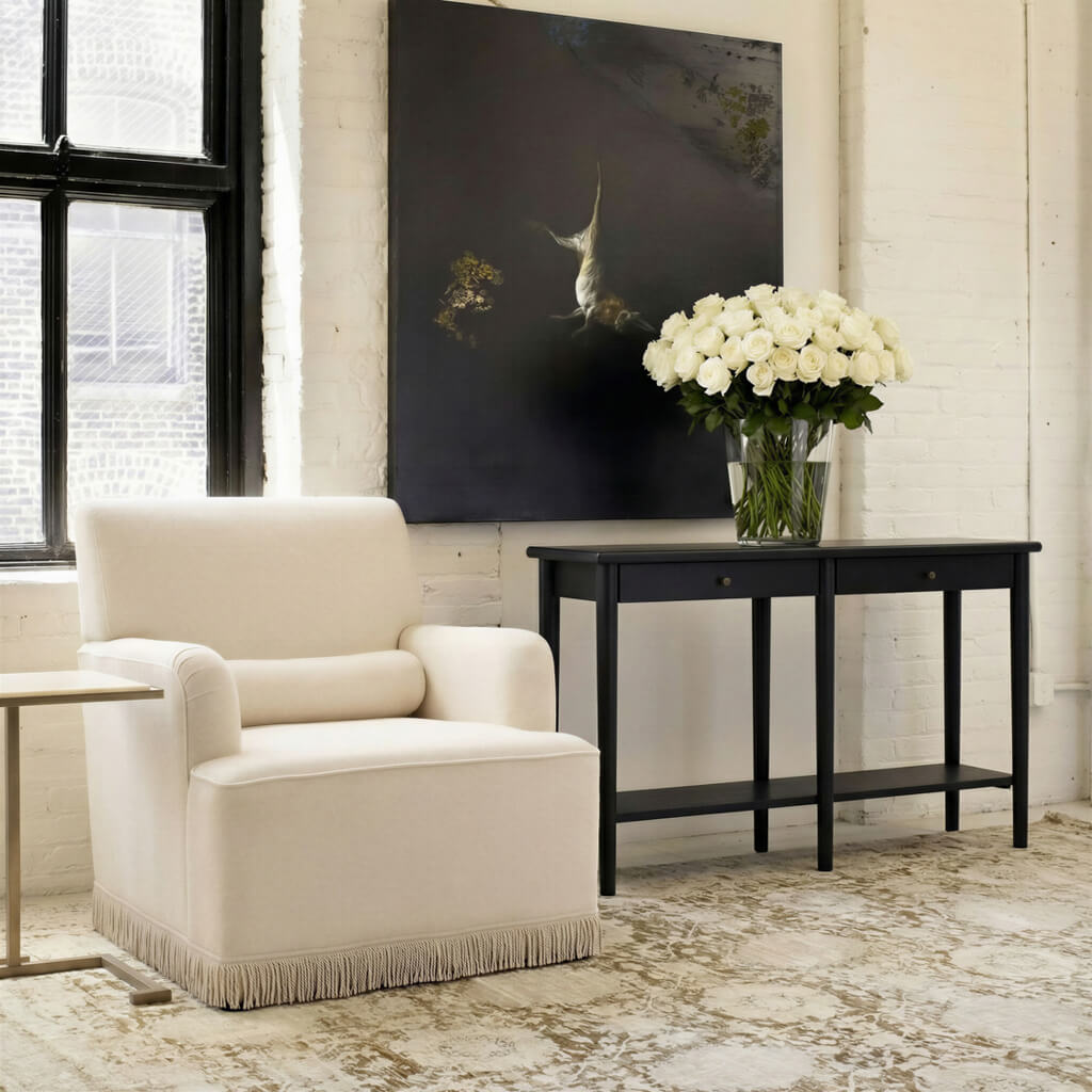 	LPD Furniture Josephine crema fabric armchair with fringe trim and bolster cushion in a classic living room setting
