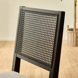 Julian Bowen Knoxley set of 2 black oak rattan back dining chairs with fabric seats in a modern dining setting