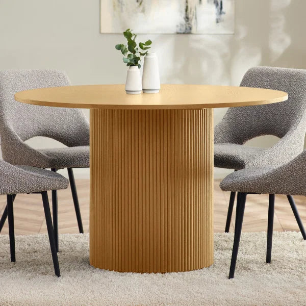 Louis fluted light oak round dining table in a contemporary dining room setting