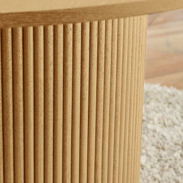 Louis fluted light oak round dining table in a contemporary dining room setting