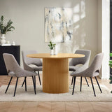 Louis fluted light oak round dining table in a contemporary dining room setting