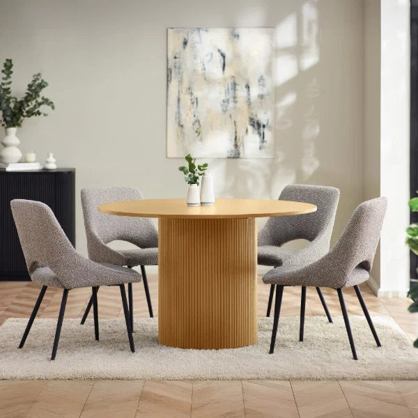 Louis fluted light oak round dining table in a contemporary dining room setting