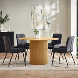 Louis fluted light oak round dining table in a contemporary dining room setting