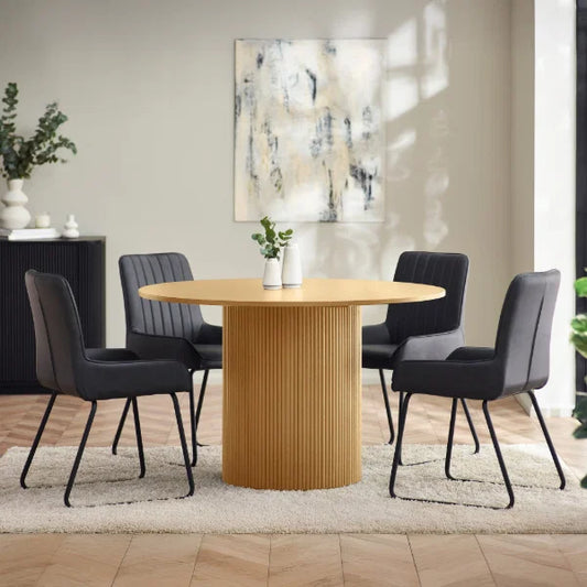 Louis fluted light oak round dining table in a contemporary dining room setting