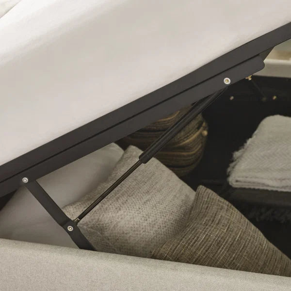 Maddock beige ottoman storage bed with split-panel headboard in a modern bedroom setting