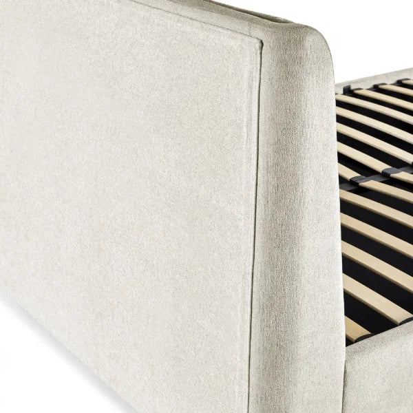 Maddock beige ottoman storage bed with split-panel headboard in a modern bedroom setting