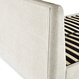 Maddock beige ottoman storage bed with split-panel headboard in a modern bedroom setting