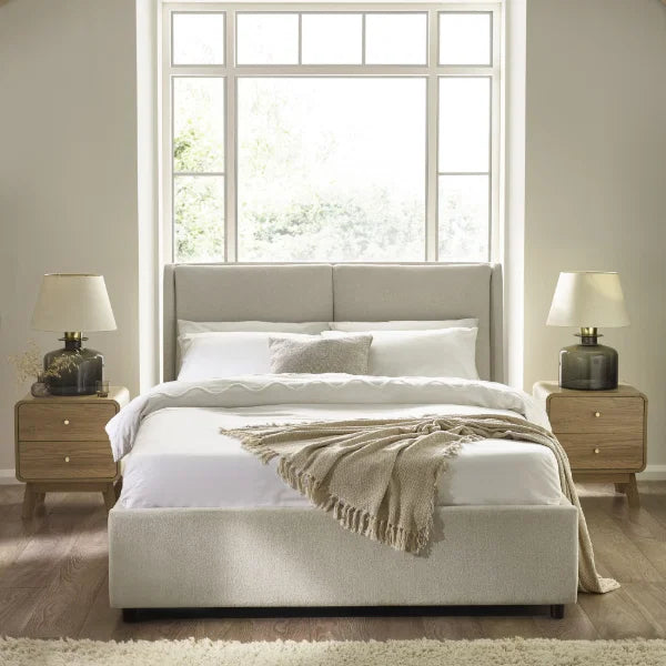 Maddock beige ottoman storage bed with split-panel headboard in a modern bedroom setting