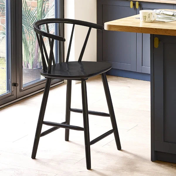 Modena black solid wood bar stool with curved spindle back in a modern kitchen setting
