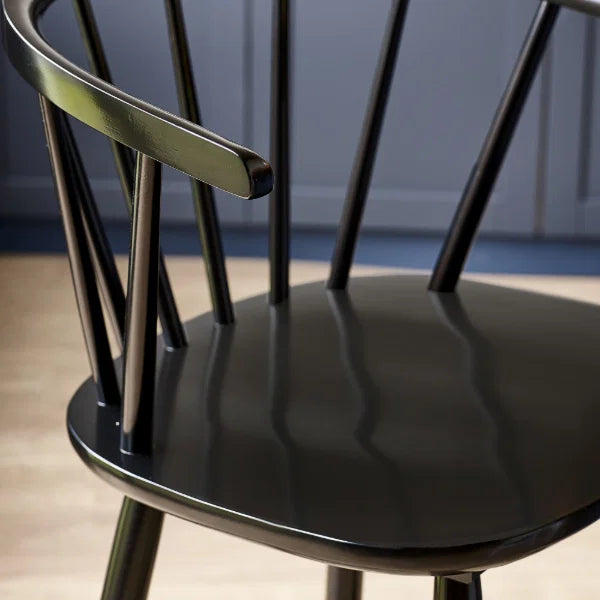 Modena black solid wood bar stool with curved spindle back in a modern kitchen setting