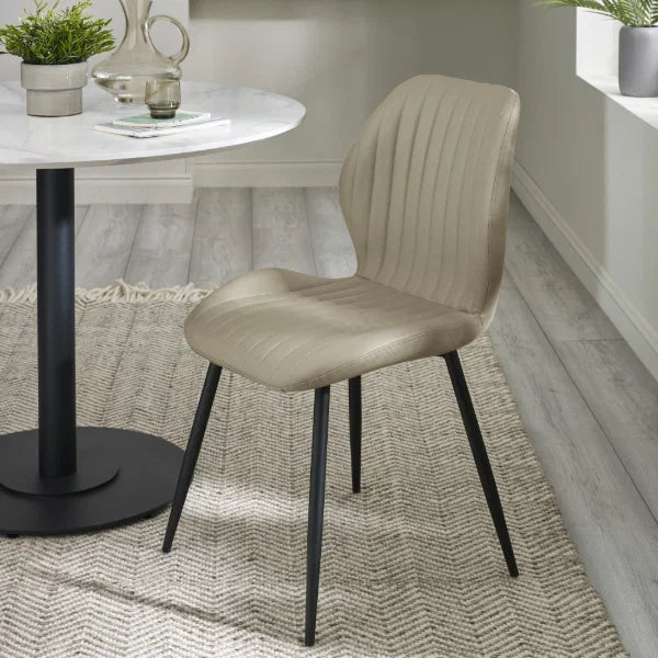 Morris set of 4 taupe faux leather dining chairs in a modern dining room setting