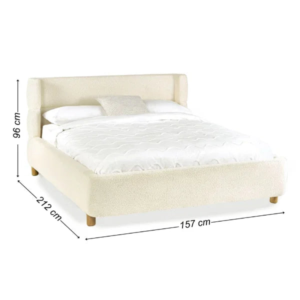 Oberon cream bouclé upholstered bed with curved padded headboard in a modern bedroom setting