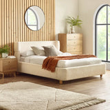 Oberon cream bouclé upholstered bed with curved padded headboard in a modern bedroom setting