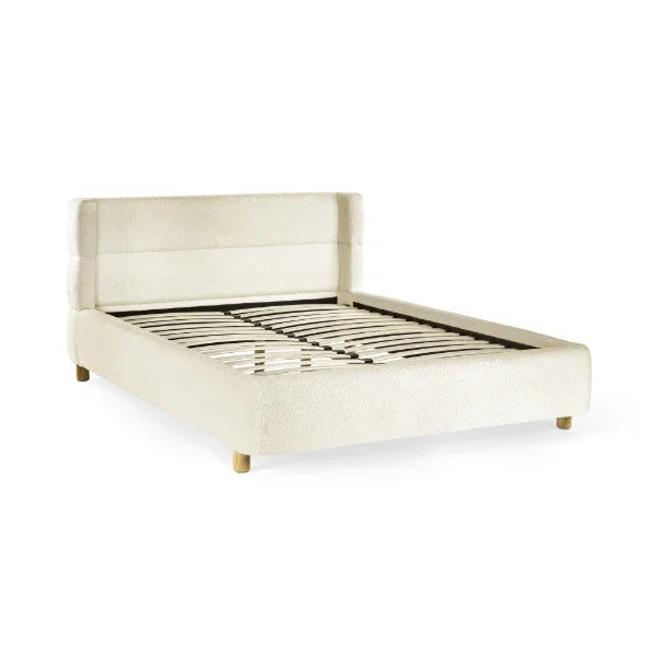 Oberon cream bouclé upholstered bed with curved padded headboard in a modern bedroom setting