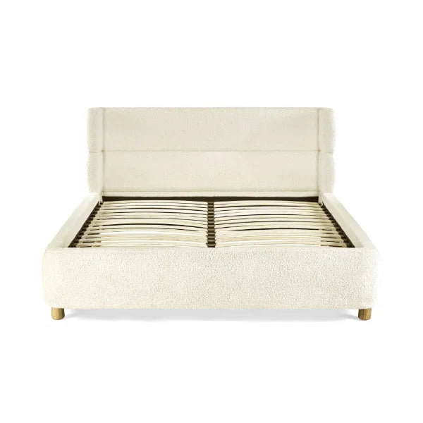 Oberon cream bouclé upholstered bed with curved padded headboard in a modern bedroom setting