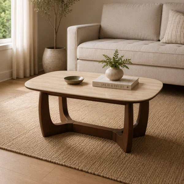 Portland marble top coffee table with sculptural walnut base in a modern living room setting