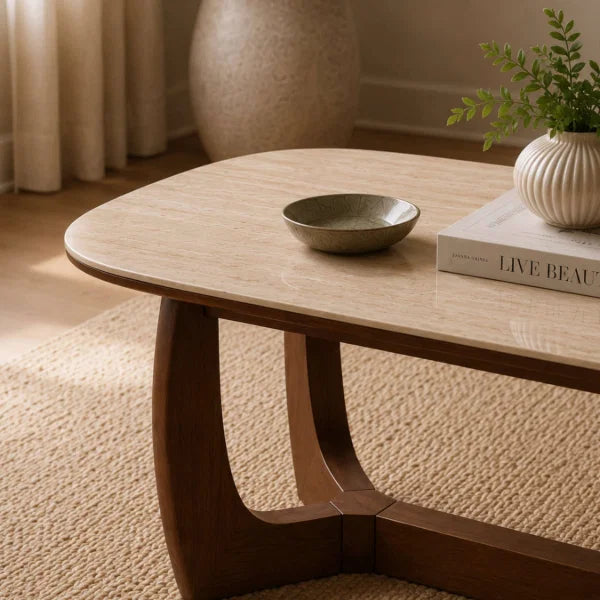 Portland marble top coffee table with sculptural walnut base in a modern living room setting