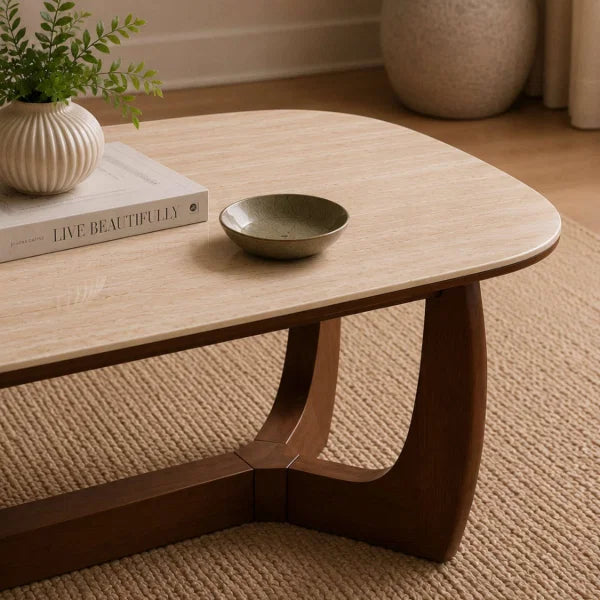 Portland marble top coffee table with sculptural walnut base in a modern living room setting