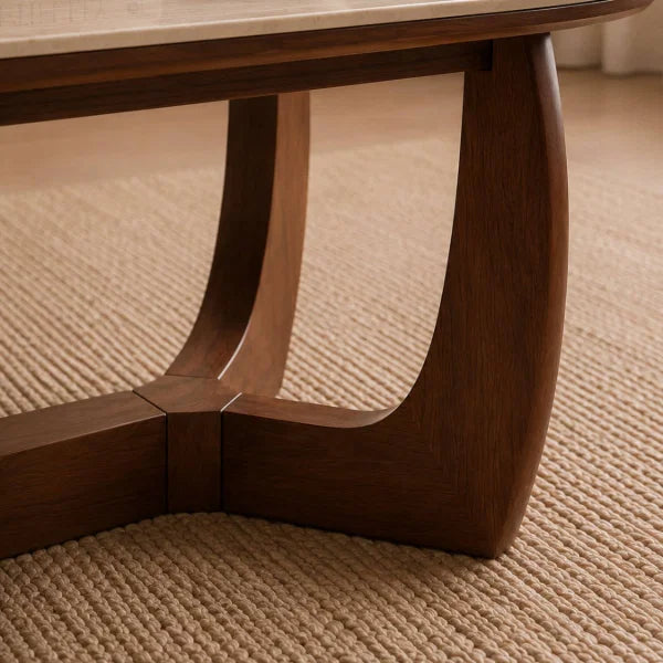 Portland marble top coffee table with sculptural walnut base in a modern living room setting