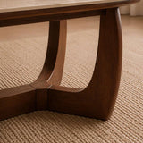 Portland marble top coffee table with sculptural walnut base in a modern living room setting