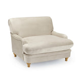 LPD Furniture Plumpton beige velvet armchair with wide cushioned seat in a modern living room setting