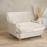LPD Furniture Plumpton beige velvet armchair with wide cushioned seat in a modern living room setting