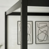 Roxanne black canopy bed with tall open four-poster frame in a modern bedroom setting