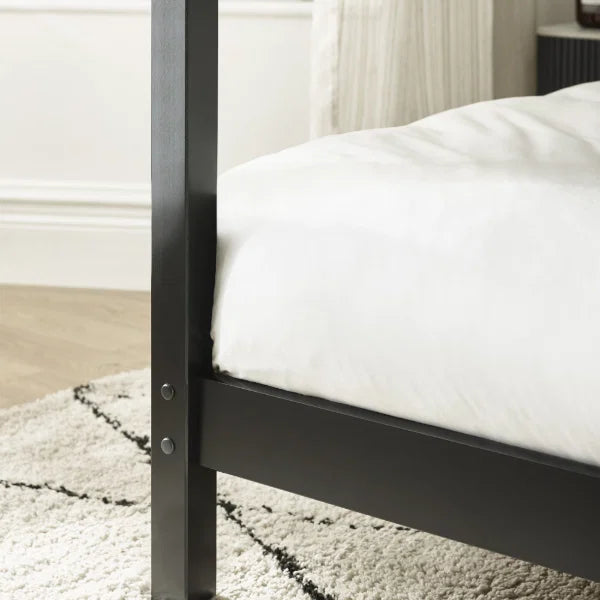 Roxanne black canopy bed with tall open four-poster frame in a modern bedroom setting