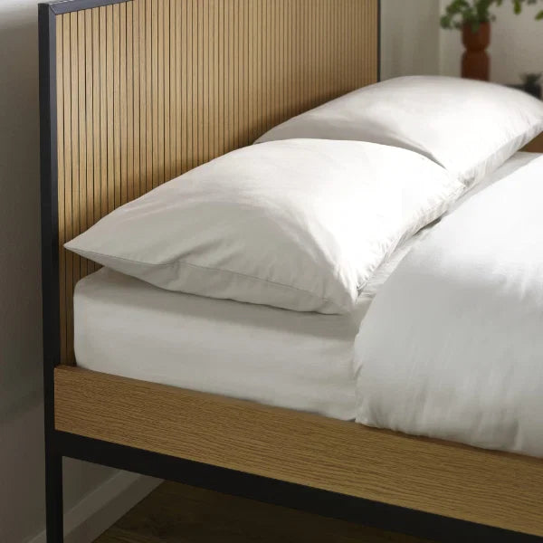 Sia grey upholstered bed frame with textured fabric finish in a modern bedroom setting