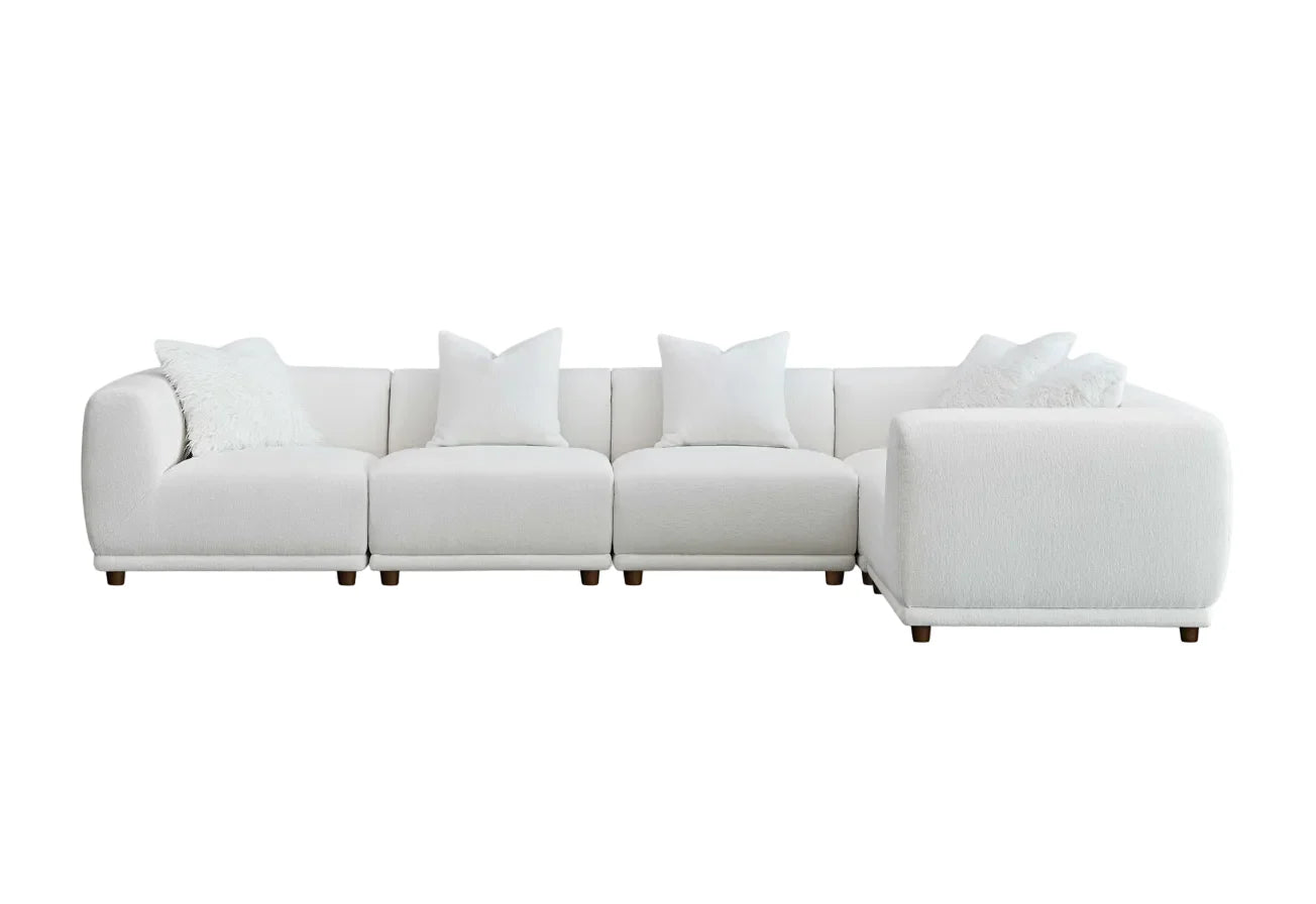 	Furnish365 Lottie modular bouclé corner sofa with scatter cushions in a modern living room setting