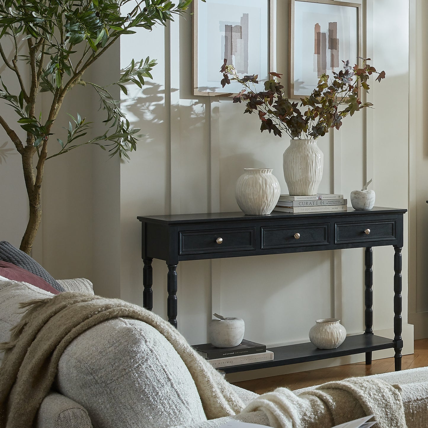 Side view of Hill Interiors Contour Collection black wooden console table with three drawers