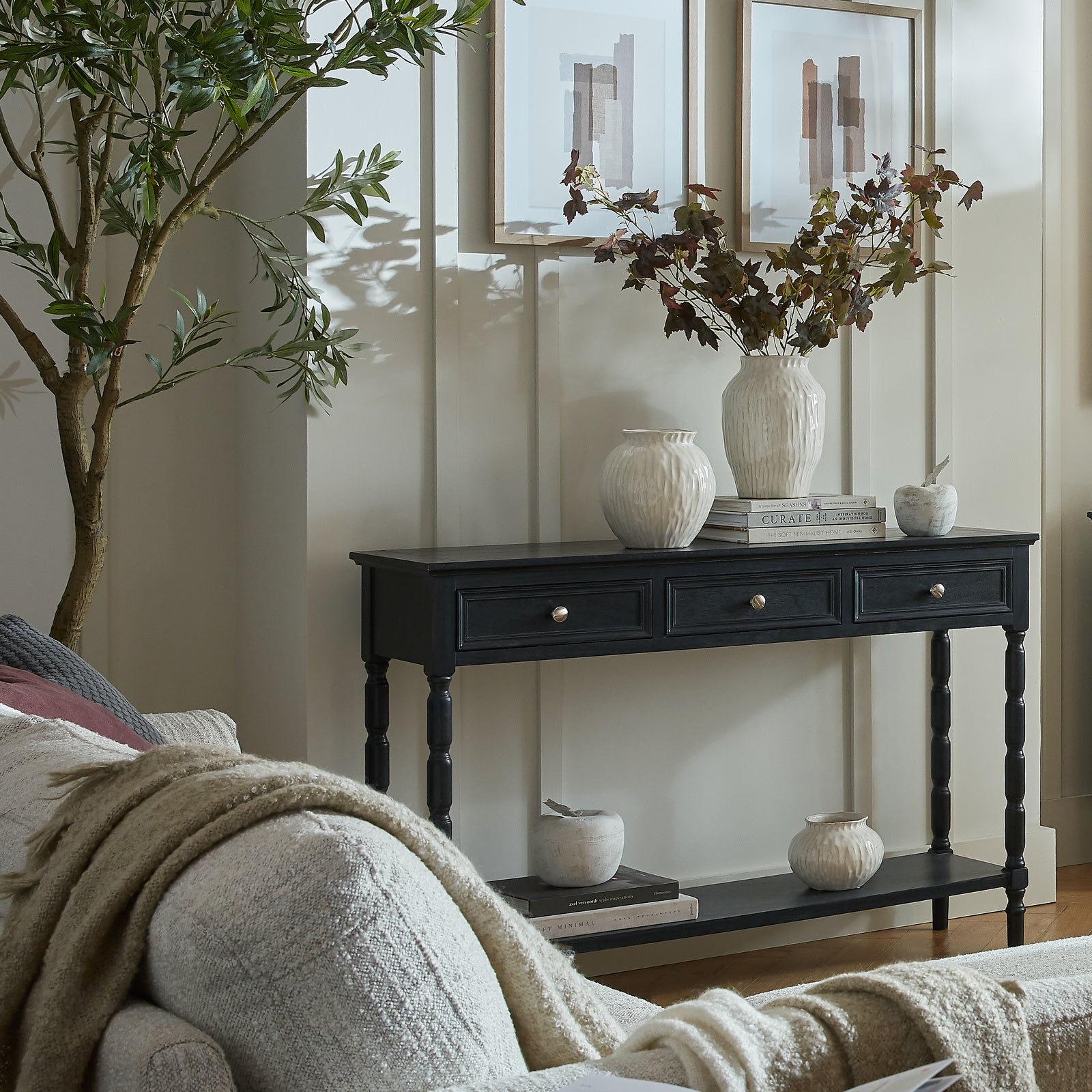 Side view of Hill Interiors Contour Collection black wooden console table with three drawers