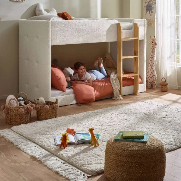 Teddy cream bouclé bunk bed with natural wood ladder in a modern kids bedroom setting