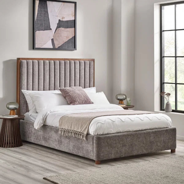 Whitmore upholstered double bed with vertical stitched headboard and walnut frame in a modern bedroom setting