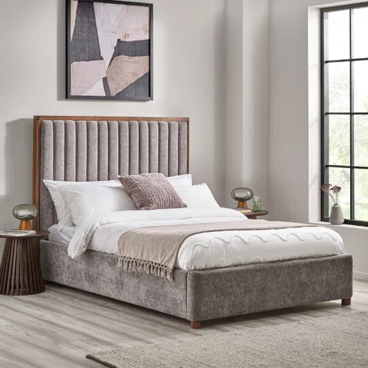 Whitmore upholstered double bed with vertical stitched headboard and walnut frame in a modern bedroom setting