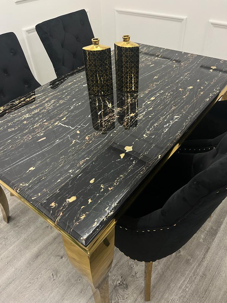 Furnish365 Astra black velvet dining chair with curved open back and gold tipped legs in a contemporary dining setting