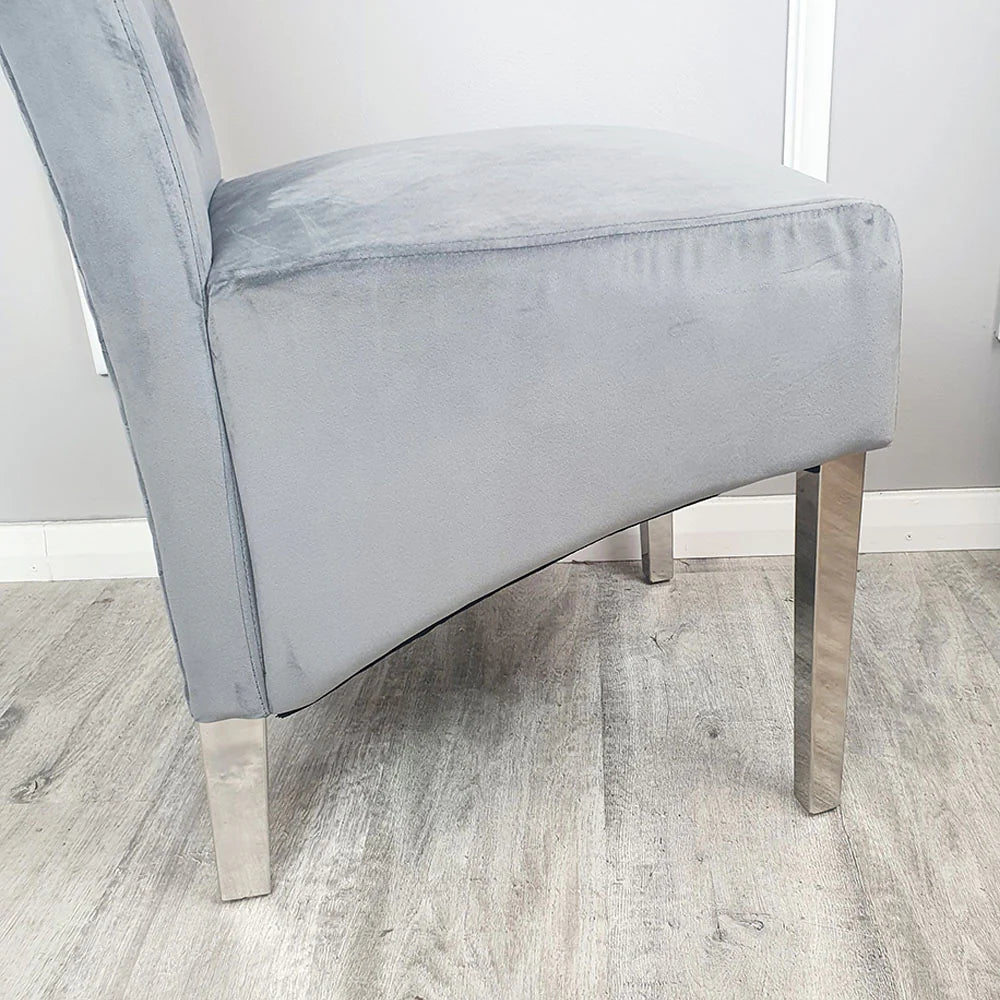 Furnish365 Emma velvet dining chair with scroll top and chrome lion knocker in an elegant dining setting