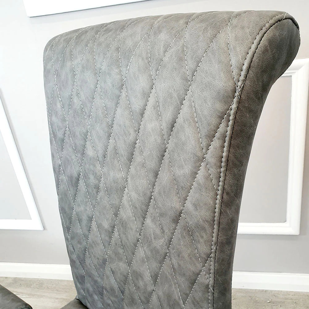 Furnish365 Nicole leather dining chair with high scroll top and chrome legs in an elegant dining setting