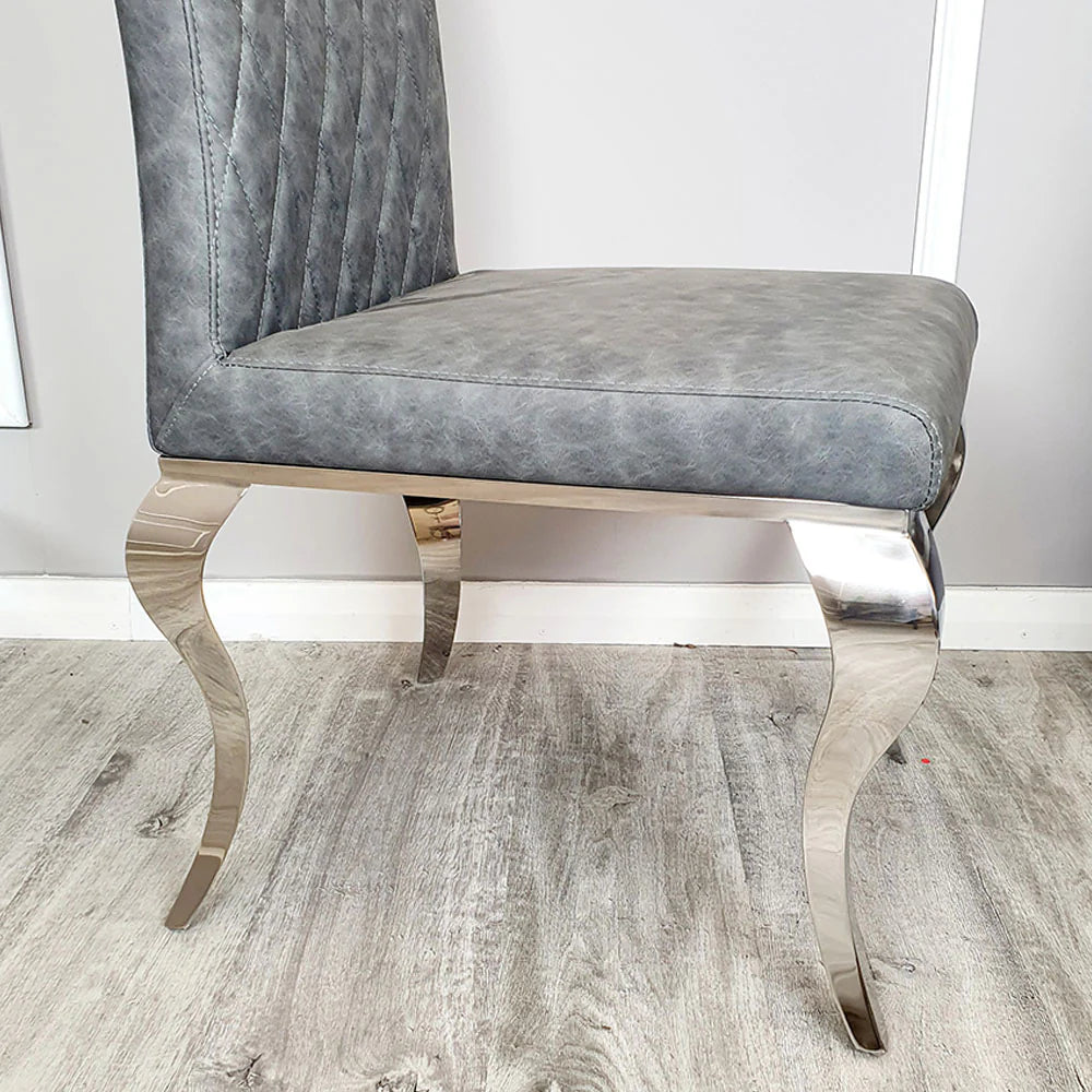 Furnish365 Nicole leather dining chair with high scroll top and chrome legs in an elegant dining setting
