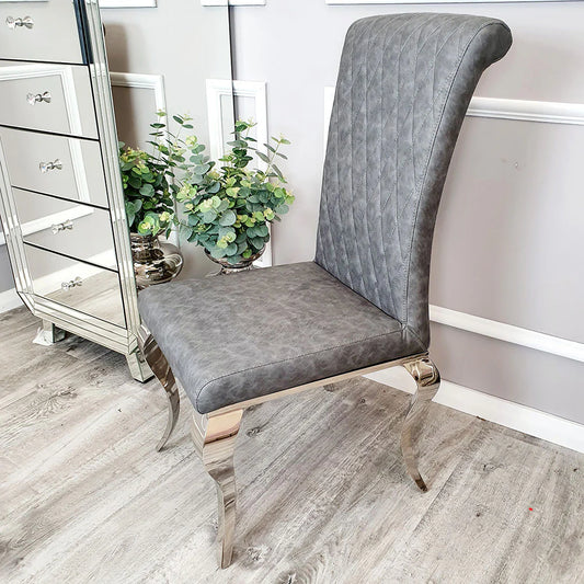 Furnish365 Nicole leather dining chair with high scroll top and chrome legs in an elegant dining setting
